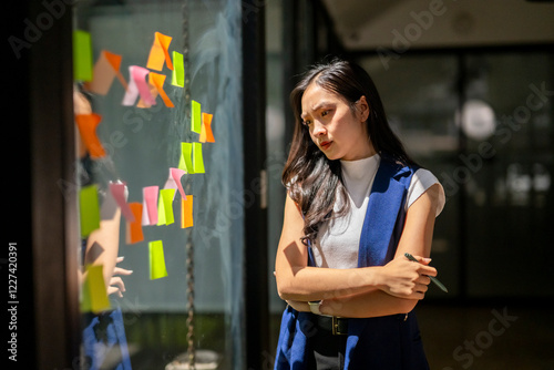 She is looking at the notes and seems to be contemplating something