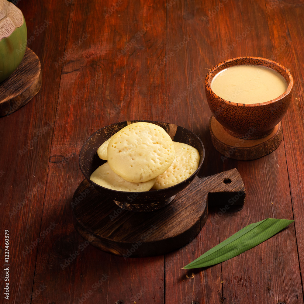 Cheese crisps are elegantly arranged in a dark bowl next to a smooth, creamy drink on a warm wooden surface Cheese crisps are elegantly arranged in a dark bowl next to a smooth, creamy drink on a warm wooden surface