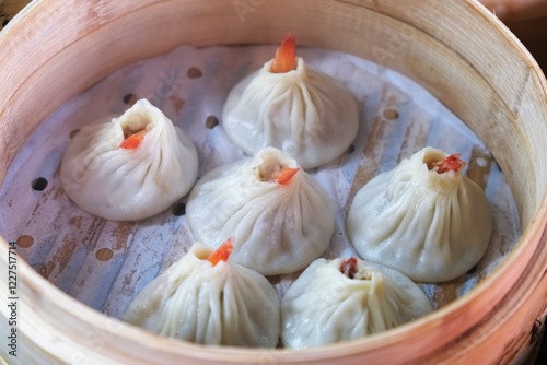 several Tangbao soup buns in steamer. Chinese food photo