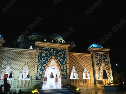 Front view mosque building under lamp light at night photo