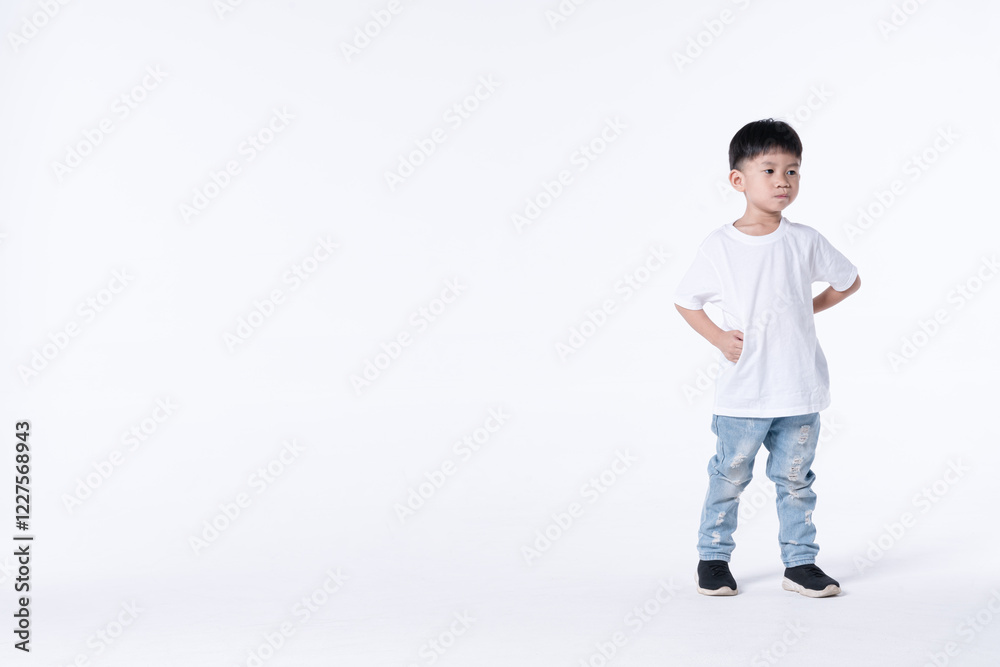 Confident Thai boy standing with hands on hips against a minimal white background. Confident Thai boy standing with hands on hips against a minimal white background.