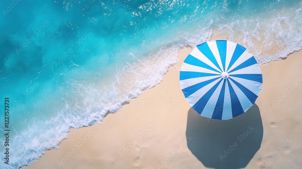 Naklejka premium Colorful Beach Umbrella on Sandy Shore with Clear Blue Ocean Waves