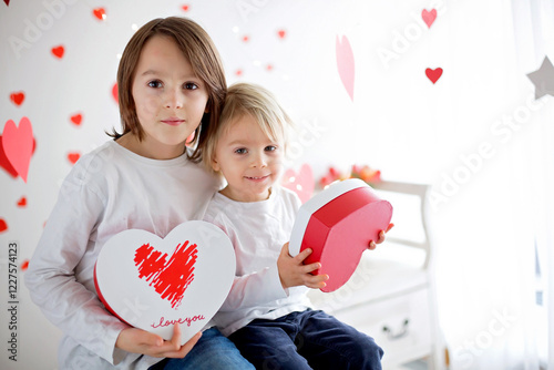 Wallpaper Mural Cute blonde toddler boy and his older brother, holding box in heart shape and flowers Torontodigital.ca