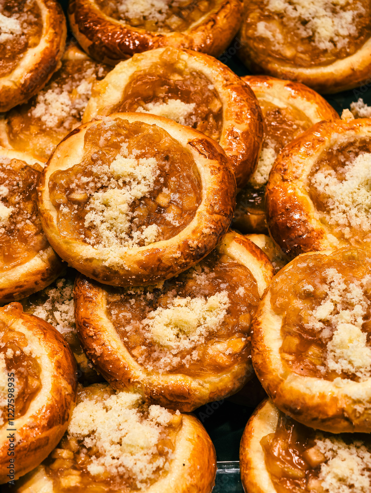 Close up of a stack of mini buns with apple filling. Close up of a stack of mini buns with apple filling.