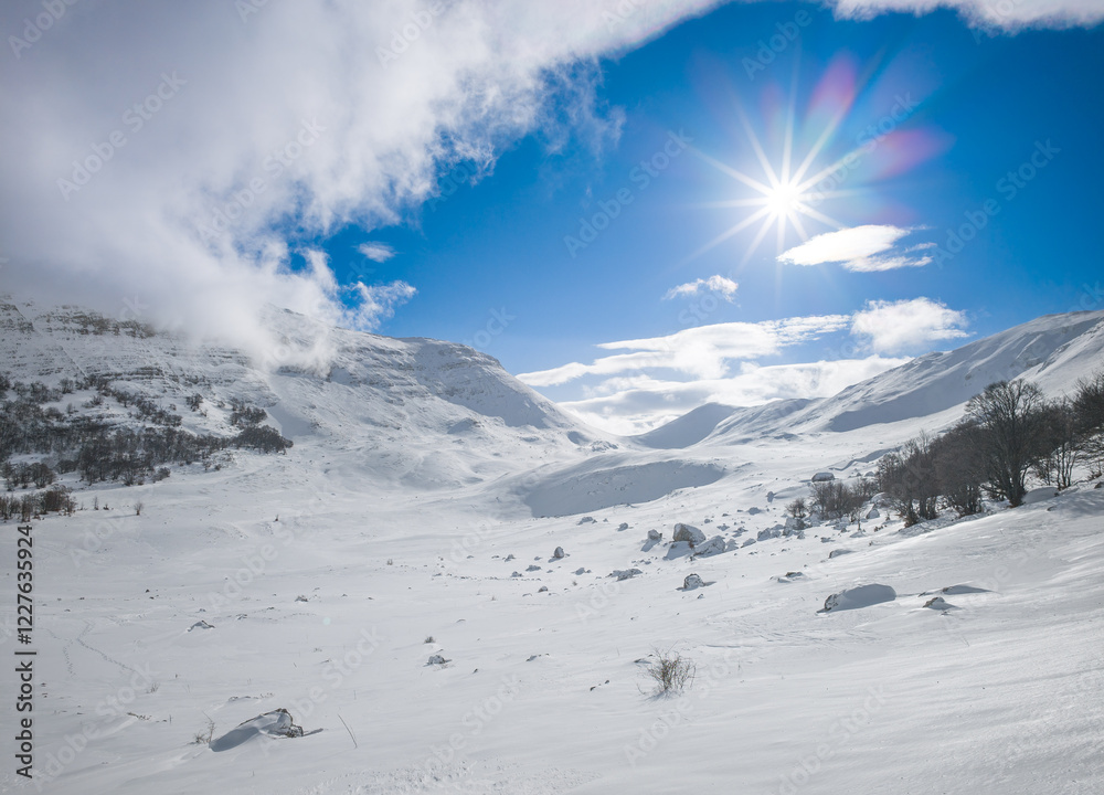 Campo Felice, Italy - The suggestive plateau peak in Abruzzo region, Monte Puzzillo and Morretano summit mount range, during the winter with snow and alpinists in altitude