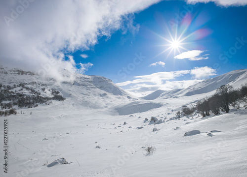 Obraz na płótnie Campo Felice, Italy - The suggestive plateau peak in Abruzzo region, Monte Puzzillo and Morretano summit mount range, during the winter with snow and alpinists in altitude w salonie