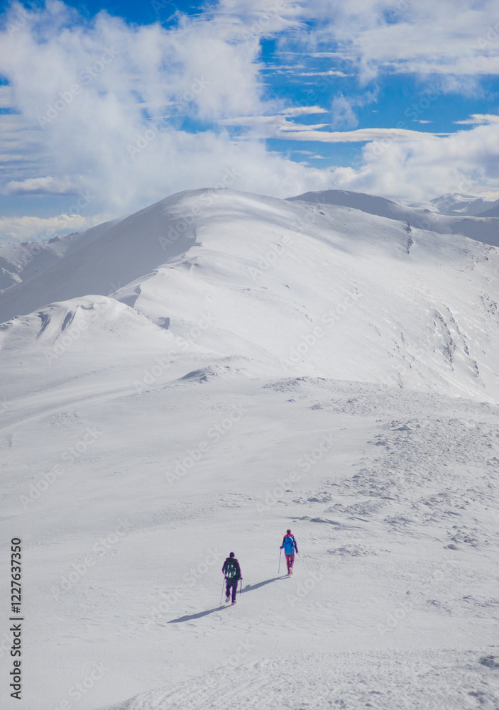 Campo Felice, Italy - The suggestive plateau peak in Abruzzo region, Monte Puzzillo and Morretano summit mount range, during the winter with snow and alpinists in altitude
