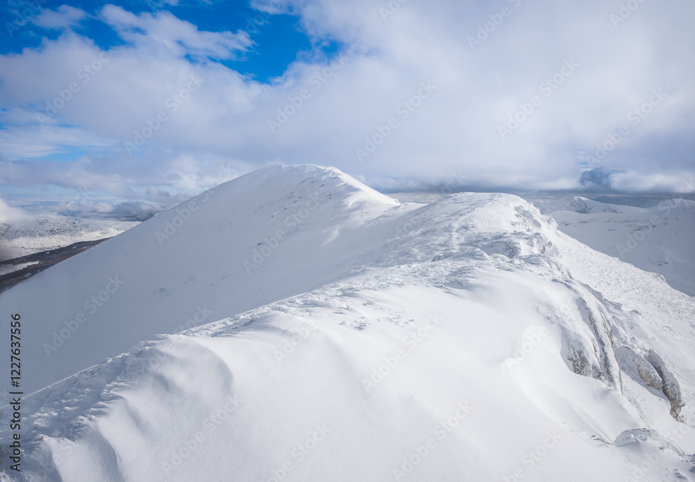 Campo Felice, Italy - The suggestive plateau peak in Abruzzo region, Monte Puzzillo and Morretano summit mount range, during the winter with snow and alpinists in altitude