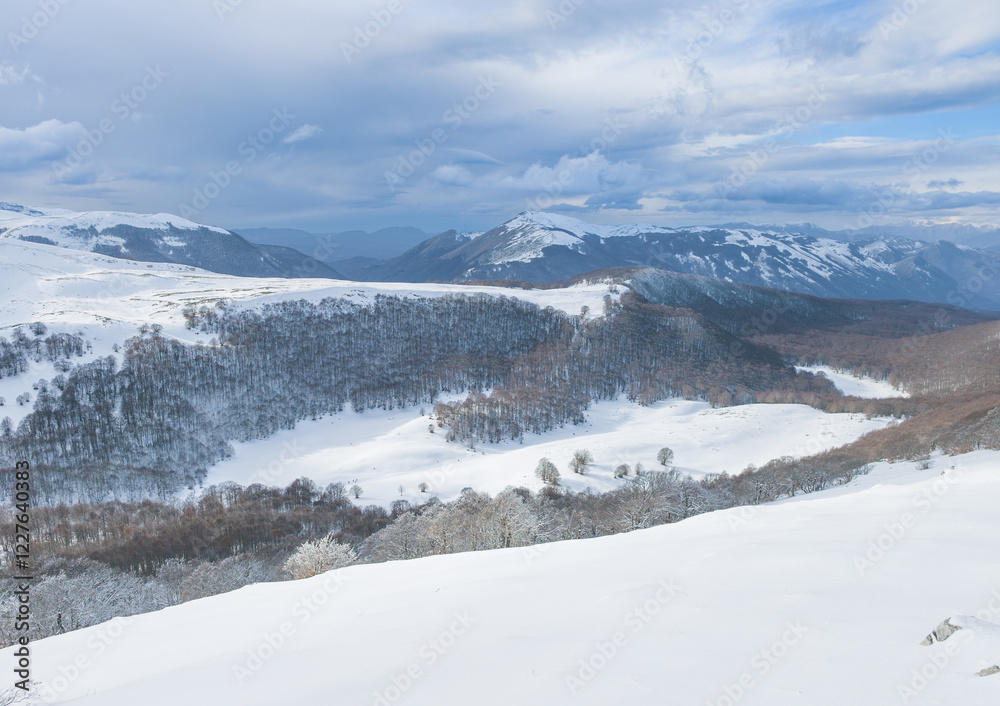 Campo Felice, Italy - The suggestive plateau peak in Abruzzo region, Monte Puzzillo and Morretano summit mount range, during the winter with snow and alpinists in altitude