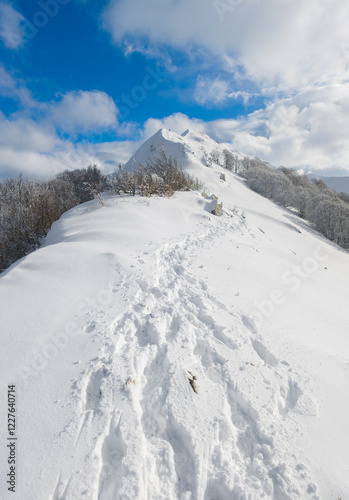 Campo Felice, Italy - The suggestive plateau peak in Abruzzo region, Monte Puzzillo and Morretano summit mount range, during the winter with snow and alpinists in altitude