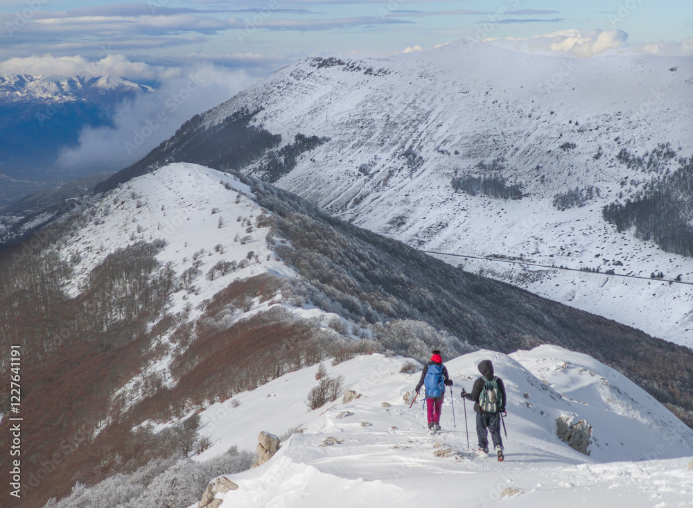 Campo Felice, Italy - The suggestive plateau peak in Abruzzo region, Monte Puzzillo and Morretano summit mount range, during the winter with snow and alpinists in altitude
