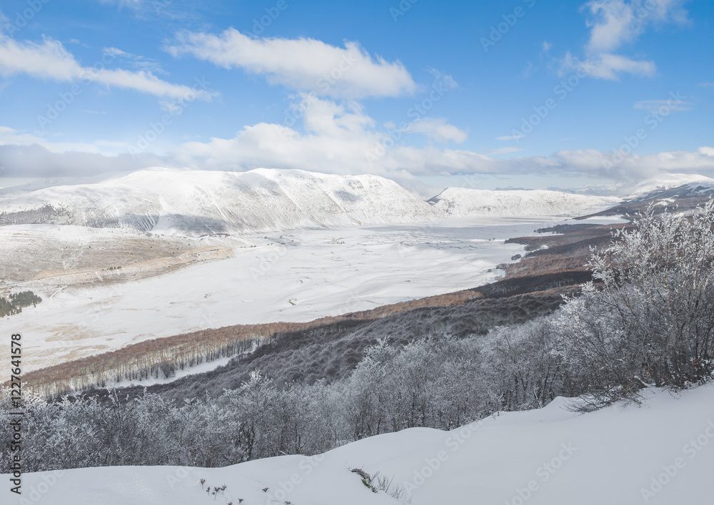 Campo Felice, Italy - The suggestive plateau peak in Abruzzo region, Monte Puzzillo and Morretano summit mount range, during the winter with snow and alpinists in altitude