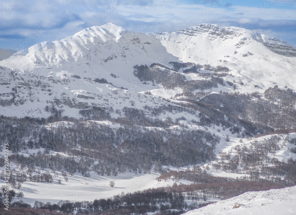 Campo Felice, Italy - The suggestive plateau peak in Abruzzo region, Monte Puzzillo and Morretano summit mount range, during the winter with snow and alpinists in altitude
