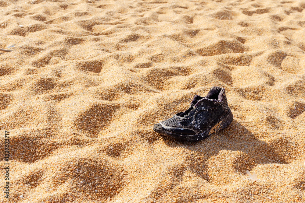 Garbage, shoes garbage the beach, sea water pollution with old shoes on sand in the beach, Environment and nature concept. Garbage, shoes garbage the beach, sea water pollution with old shoes on sand in the beach, Environment and nature concept.