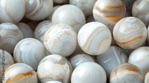 Natural white oxalate agate gemstone spheres displayed in a pile showcasing intricate patterns and textures for decorative use.