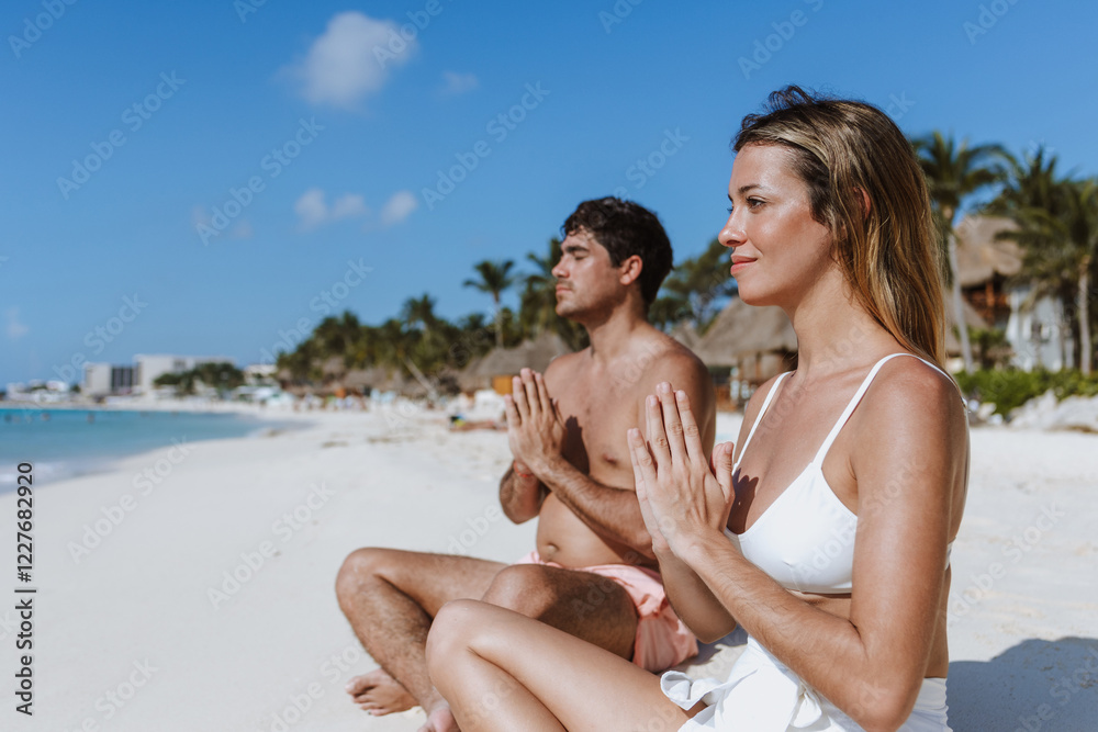 young hispanic couple woman and man in meditation and relaxation time on the beach in Mexico Latin America, Caribbean and tropical destination young hispanic couple woman and man in meditation and relaxation time on the beach in Mexico Latin America, Caribbean and tropical destination