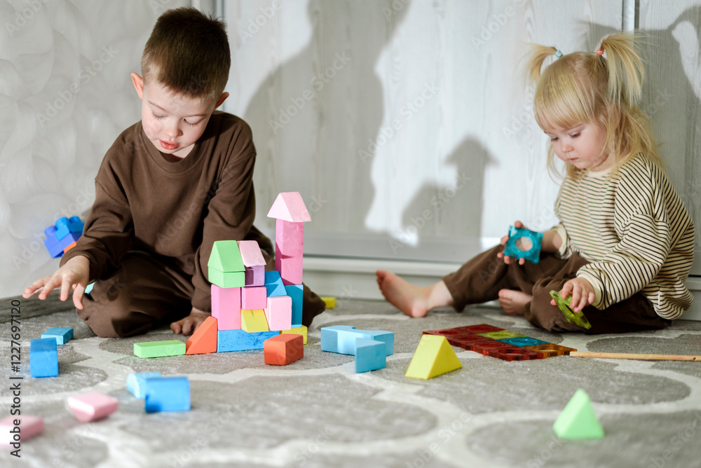 Children playing with toys on the floor at home Children playing with toys on the floor at home