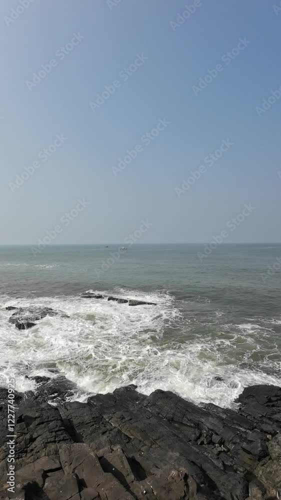 Ocean Waves Crashing On The Big Black Rocks On The Seashore Ocean Waves Crashing On The Big Black Rocks On The Seashore