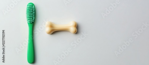 Green Toothbrush and Dental Toy Bone on White Background with Copy Space for Pet Care and Hygiene Concepts photo