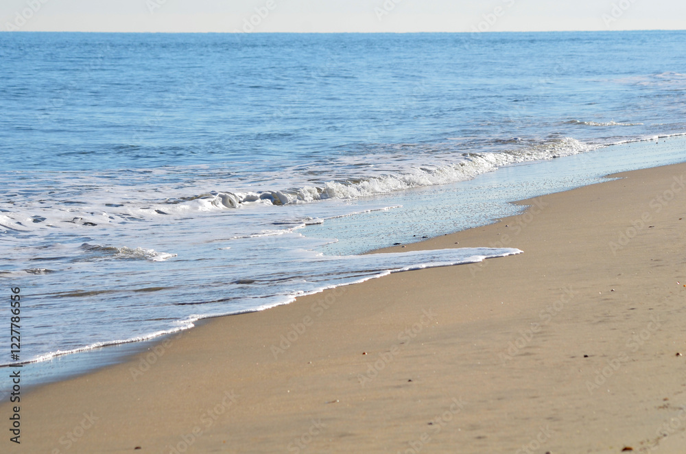 Beach at Cape Henlopen with calm waves cropped with no people Beach at Cape Henlopen with calm waves cropped with no people
