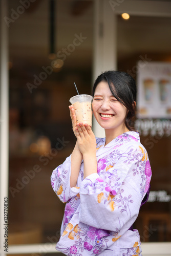 Japanese woman smile with yukata dress and milk tea in hand