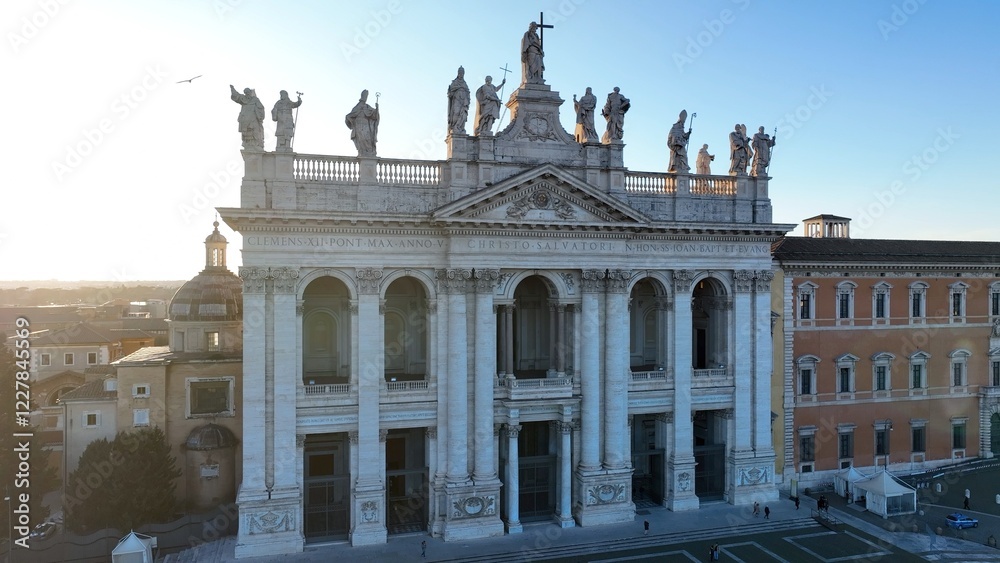 Obraz premium Controluce sulla basilica di San Giovanni in Laterano a Roma Vista aerea della facciata e delle statue sul tetto della basilica