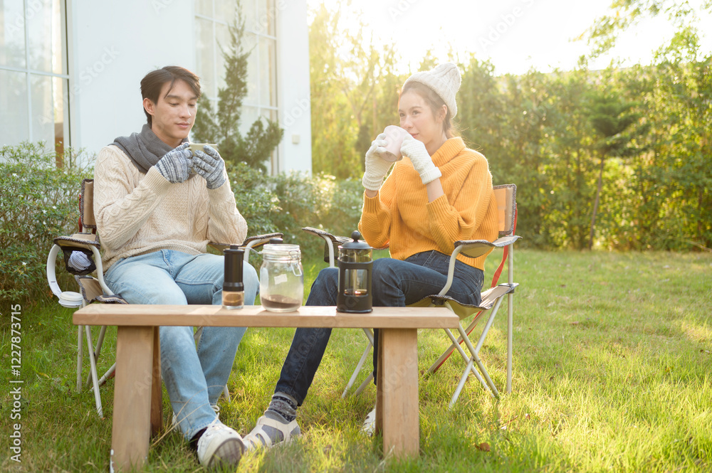 Enjoying Warm Drinks and Conversation in a Sunny Outdoor Garden During Autumn Afternoon Enjoying Warm Drinks and Conversation in a Sunny Outdoor Garden During Autumn Afternoon