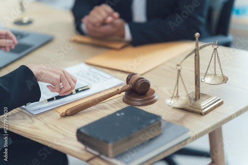 Scales of Justice: A gavel, scales of justice, legal documents, and a law book are laid out on a wooden table.  A lawyer or judge sits at the table, ready to weigh evidence, uphold the law.
