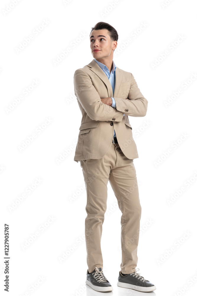 confident businessman in beige suit looking up to side confident businessman in beige suit looking up to side
