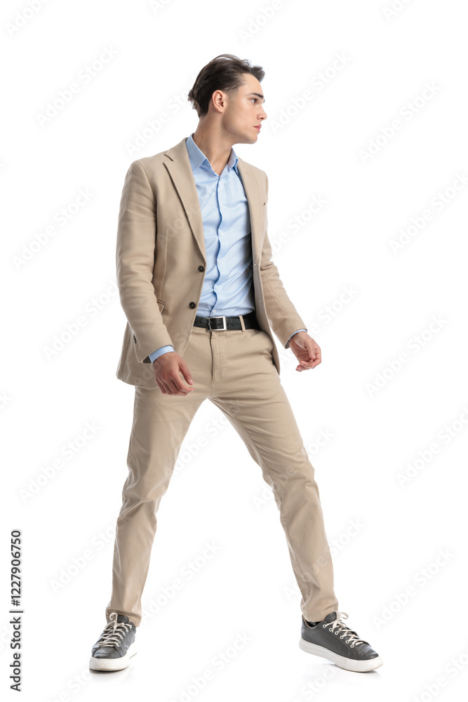 masculine smart casual man with parted feet looking to side masculine smart casual man with parted feet looking to side