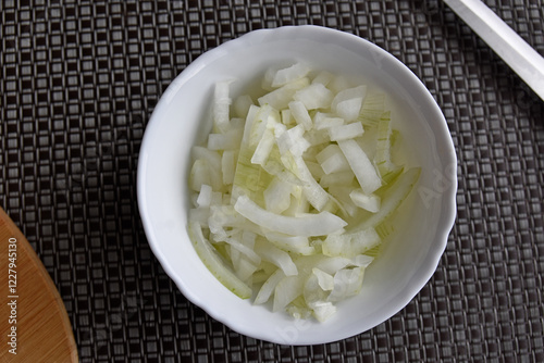 Chopped onion in a white bowl