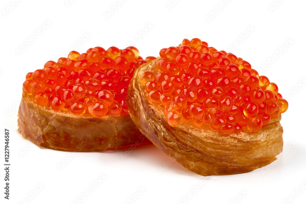 Red caviar on a crispy bread slice, isolated on white background. Red caviar on a crispy bread slice, isolated on white background.