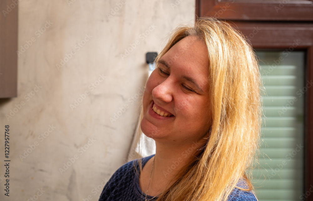 Smiling woman enjoying a joyful moment in a cozy kitchen during daytime at home Smiling woman enjoying a joyful moment in a cozy kitchen during daytime at home
