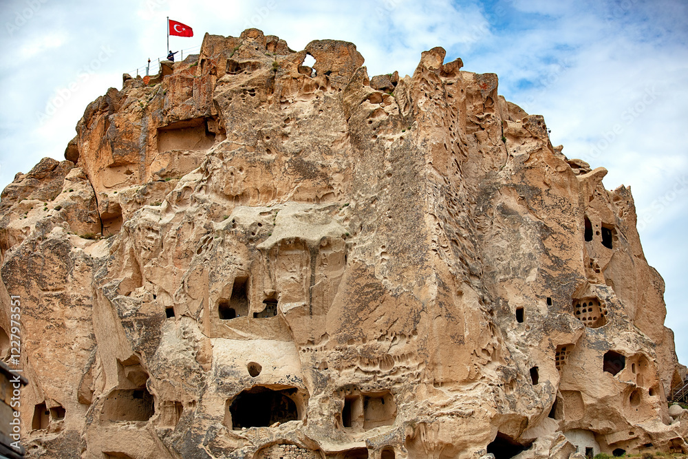 Exploring the ancient rock formations and cave dwellings in Cappadocia at dusk