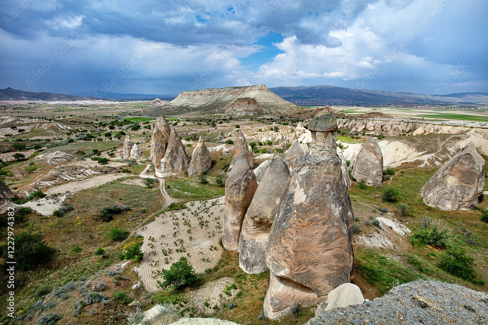 Unique rock formations rise majestically under a dramatic sky in a scenic landscape