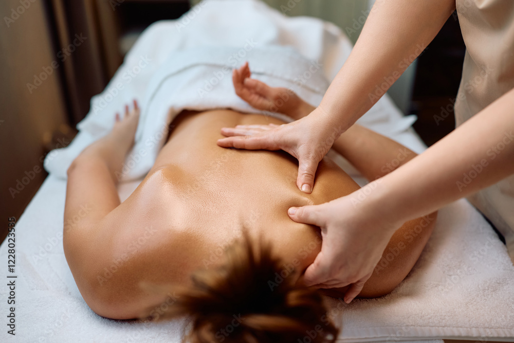 Fototapeta premium Unrecognizable woman having back massage at health spa.