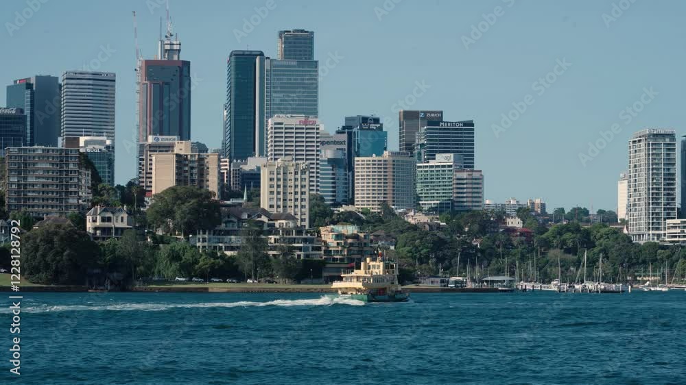 Sydney Ferry Boat Cruising In The Harbour With North Sydney Skyline In New South Wales, Australia. - wide shot Sydney Ferry Boat Cruising In The Harbour With North Sydney Skyline In New South Wales, Australia. - wide shot