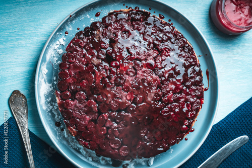 Cherry chocolate clafutis on a light blue plate. French pie according to a traditional recipe. A quick homemade dessert. photo