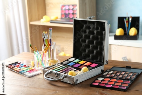 Face paints and tools on wooden table indoors