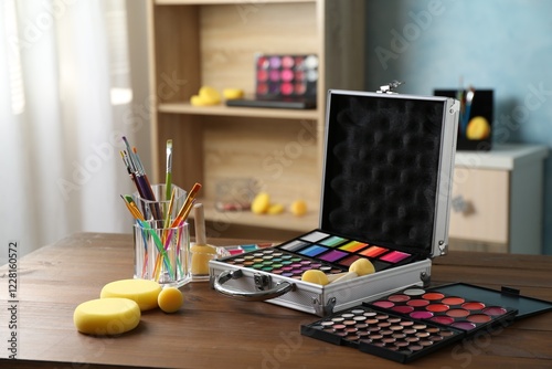 Face paints and tools on wooden table indoors. Space for text