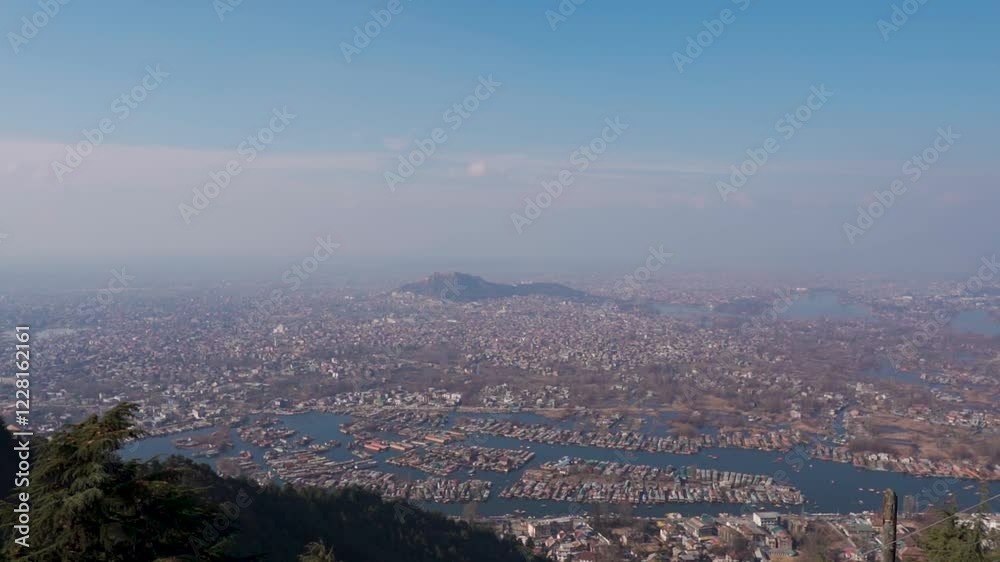 Wide angle shot of Srinagar city as seen from above the mountains besides it from Shankaracharya temple at Srinagar in Jammu and Kashmir, India. City with Dal lake and Akbar fort seen from above. Wide angle shot of Srinagar city as seen from above the mountains besides it from Shankaracharya temple at Srinagar in Jammu and Kashmir, India. City with Dal lake and Akbar fort seen from above.