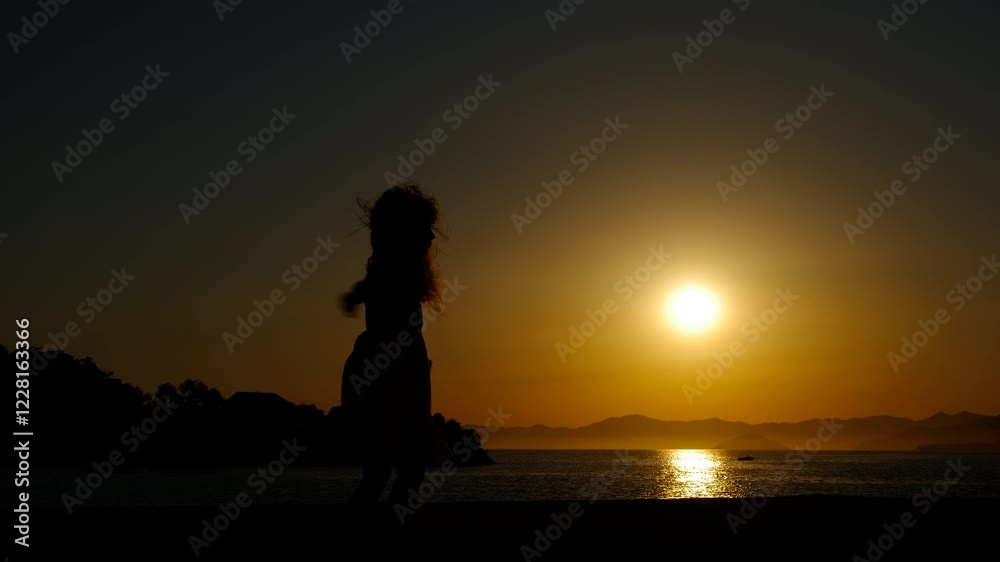 Child watch a beautiful lake dusk. A little girl silhouette with open hands spinning during dusk by the lake. Child watch a beautiful lake dusk. A little girl silhouette with open hands spinning during dusk by the lake.