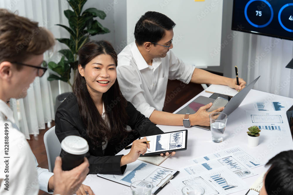Analyst team utilizing BI Fintech to analyze financial data at table in meeting room. Businesspeople analyzing BI dashboard power on paper for business insight and strategic marketing planning.Prudent Analyst team utilizing BI Fintech to analyze financial data at table in meeting room. Businesspeople analyzing BI dashboard power on paper for business insight and strategic marketing planning.Prudent