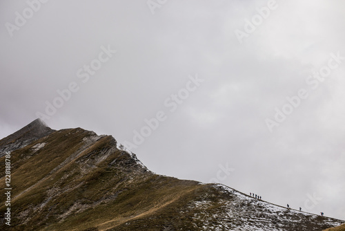 People hiking toward a mountain peak