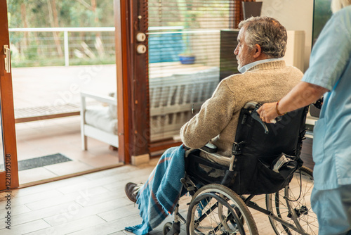 Nurse pushing elderly man in wheelchair, looking outside