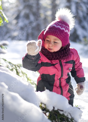 A child knocks snow from a tree
