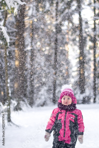 It's snowing in the forest, a girl is walking