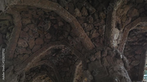 Stone arch ceiling with intricate design at Park Güell, Barcelona, Spain, outdoors