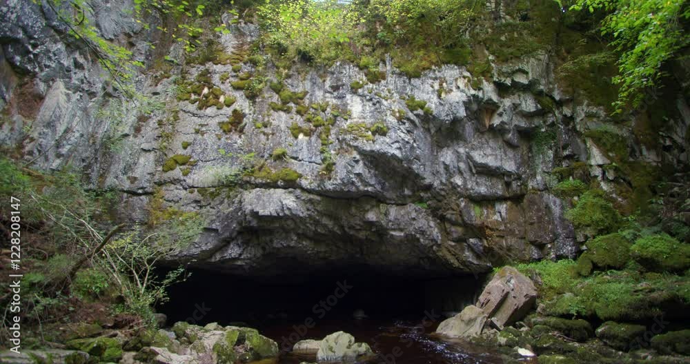 shot of Porth yr Ogof Cave roof entrance with the river Mellte flowing inside The Cave shot of Porth yr Ogof Cave roof entrance with the river Mellte flowing inside The Cave