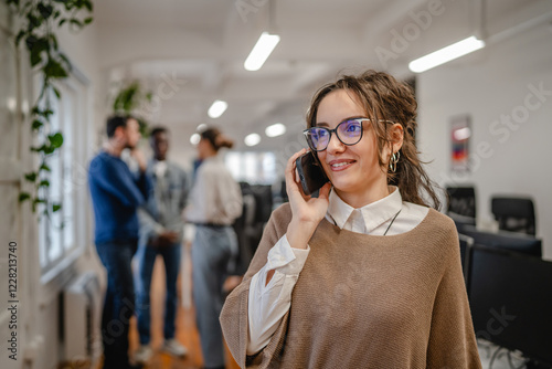 Portrait of beautiful young woman talk on mobile phone in the office